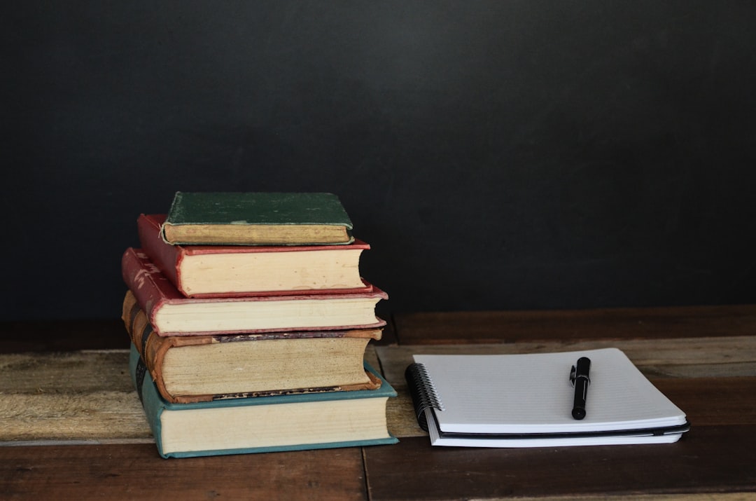 『習慣が10割』を要約する — 積み上がった本とノートのある読書デスク